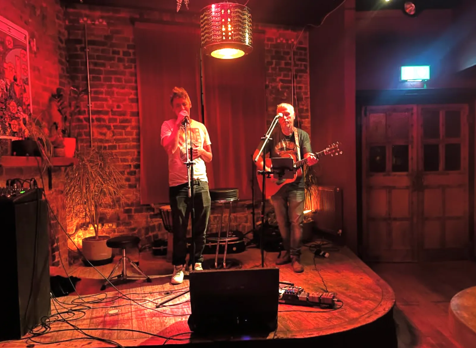 The Girl From Tomorrow performing under red stage light